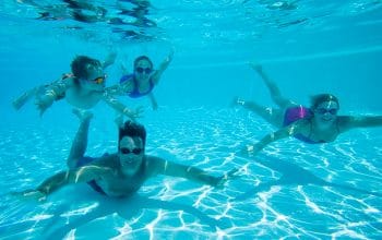 Family Swimming Underwater